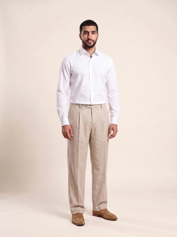 DAFLEEN model in a white shirt and oat trousers